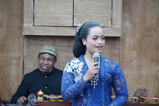 Blitar, East Java, Indonesia - June 17th, 2022 : The sinden (Javanese singer traditional song) on Blitar Jadul. Blitar jadul was held for the anniversary of the city of Blitar