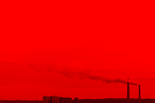 Factory smoke over the city . Red sky with toxic smoke