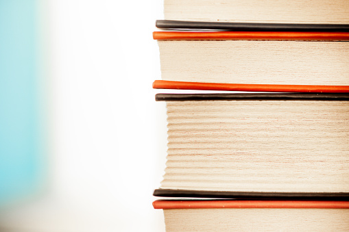 A stack of old books lies on the table.