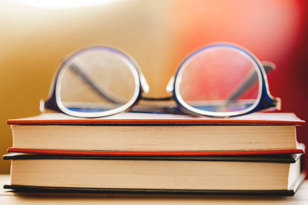 A stack of old books lies on the table.