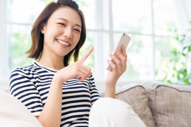 istock attractive Asian woman using a smart phone 1461471763