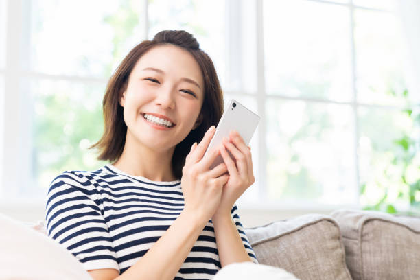 istock attractive Asian woman using a smart phone 1461471884