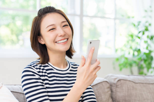 istock attractive Asian woman using a smart phone 1461471887