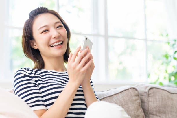istock attractive Asian woman using a smart phone 1461471935