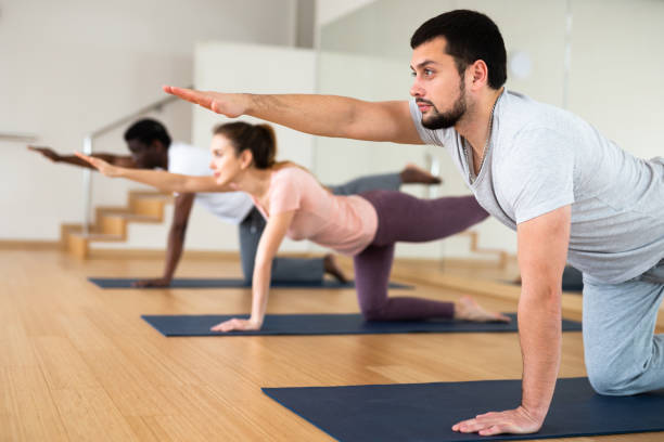 istock Bearded man standing in balancing asana Dandayamna Bharmanasana 1461472823