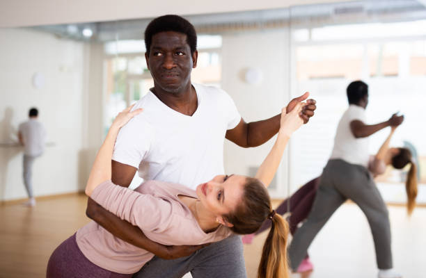 istock Man and woman practicing salsa moves in dancing room 1461472911