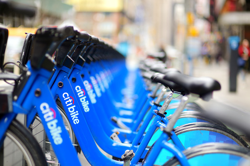 New York - March 15, 2015: Row of Citi bike rental bicycles at docking station in New York City. Shared bikes lined up in the street of New York, USA.