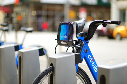 New York - March 15, 2015: Row of Citi bike rental bicycles at docking station in New York City. Shared bikes lined up in the street of New York, USA.