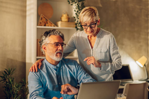 istock Senior couple using a laptop at home 1461476910