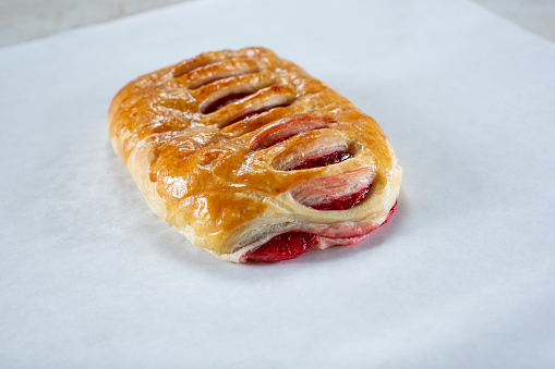 A view of a strawberry danish pastry.