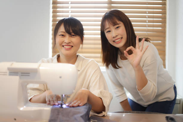 istock A woman learning how to use a sewing machine 1461482319