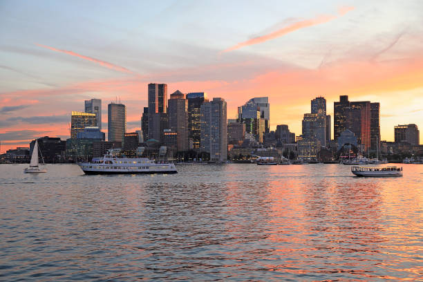 Boston skyline and harbor at sunset with Atlantic Ocean on the foreground Boston skyline and harbor at sunset with Atlantic Ocean on the foreground, USA passenger craft stock pictures, royalty-free photos & images