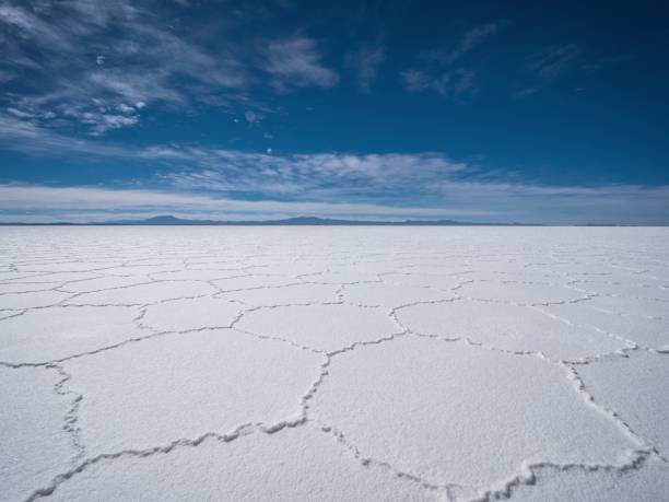 Endless boundless infinite vastness dreamy landscape of hexagonal shape white salt flat lake Salar de Uyuni in Bolivia stock photo