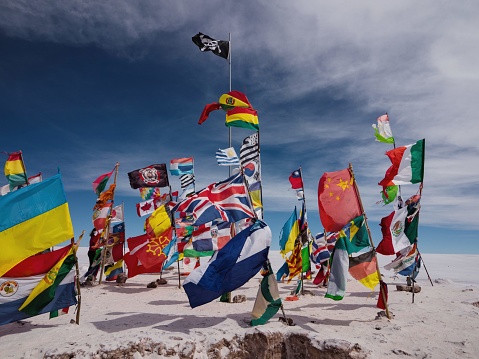 Panorama view of various different nation country flags from all over the world on Salar de Uyuni dry salt flat lake in Potosi, Bolivia South America