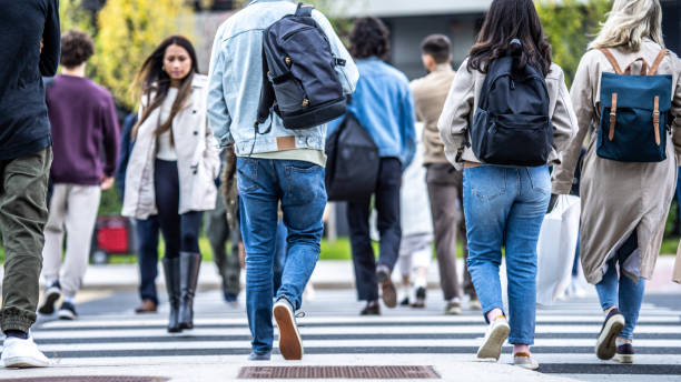 istock Crowd of people walking across zebra in city 1461485651