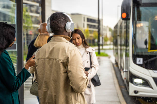 istock Man in headphones waiting for bus boarding 1461485658