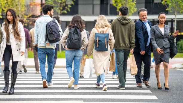 istock Diverse people crowd rushing across crosswalk 1461485670