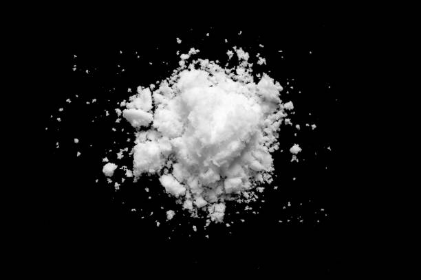 istock White snow isolated on black background close up 1461486420