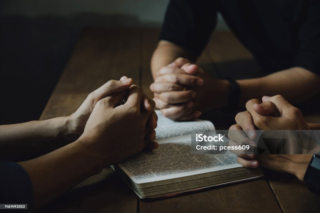 Christians and Bible study concept. Christians held each other's Christians and Bible study concept. Christians held each other's hands praying together and seeking the blessings of God,  They were reading the Bible and sharing the gospel. praying worship believe. Apostle - Worshipper Stock Photo