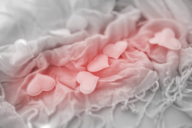 Valentines day or wedding greeting card, pink hearts on light  delicate soft background of  fabric folds , love and wedding  concept.