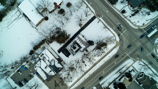Looking down on an intersection form a high angle view during the winter in a subdivision