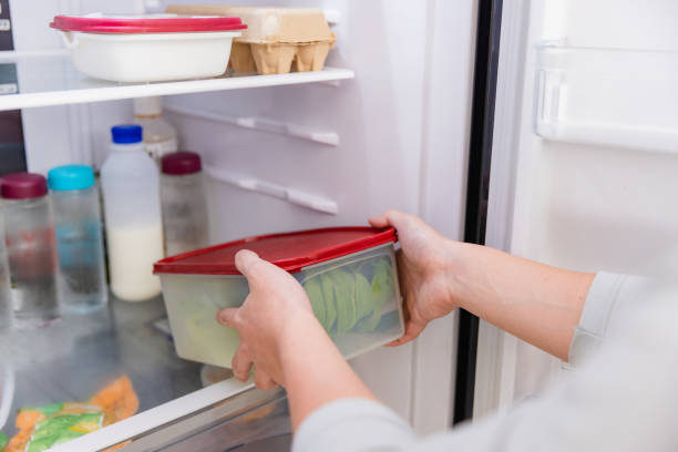 istock Asian man put vegetable in refrigerator in kitchen. 1461501812