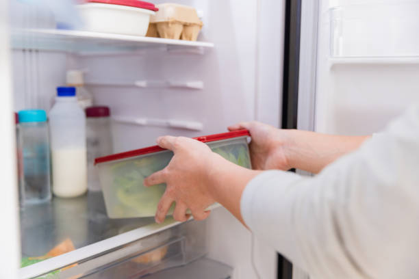 istock Asian man put vegetable in refrigerator in kitchen. 1461501819