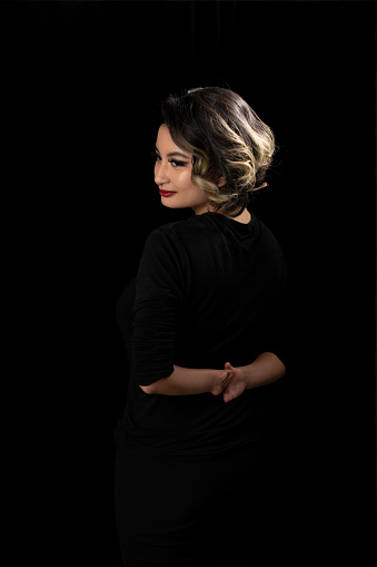 Back view of beauty portrait of a Malay young woman with a disability in a studio