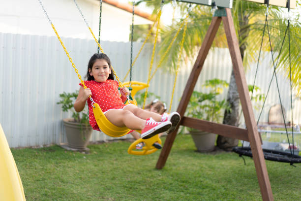 istock Girls in backyard playground 1461503364