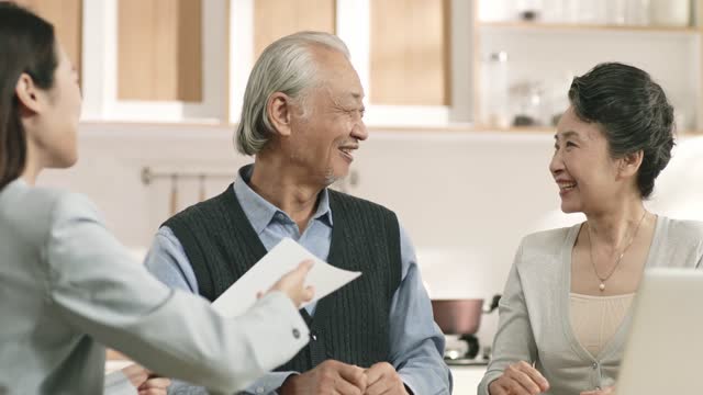 senior asian couple happily signing agreement
