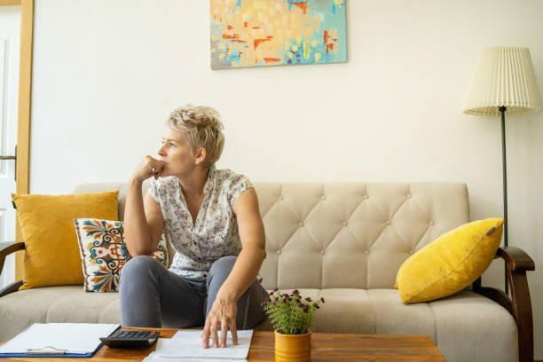 A woman worrying about the cost of living stock photo