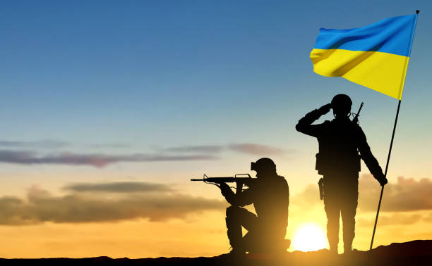 istock Silhouettes of soldiers with Ukraine flag 1461515225