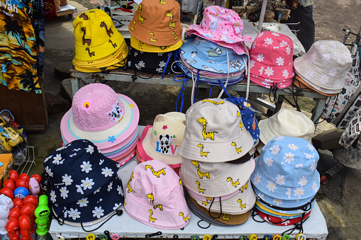 Malang, 24 Desember 2022 - Colorful children's hat and many of hat stacks in the hat shop
