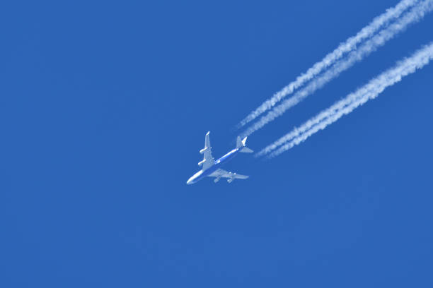 istock Jetliner and contrails flying in the blue sky. 1461531439