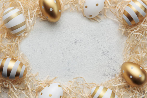 istock Easter eggs painted with gold paint on a straw background 1461533528