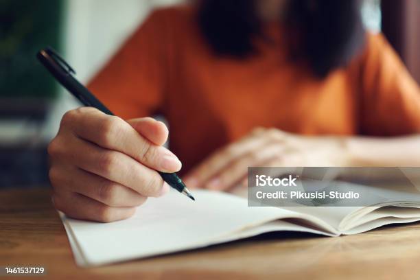 Close Up Woman Hand Writing On Notebook Stock Photo - Download Image Now - Writing - Activity, Handwriting, Note Pad