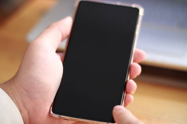 istock Smart phone mockup, businessman holding phone with black screen template 1461538038