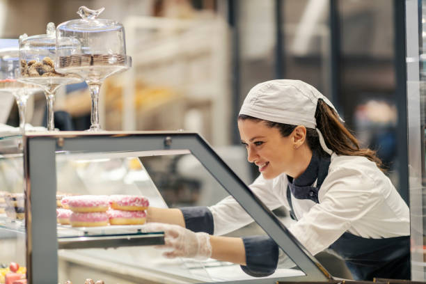 istock A bakery worker is selling doughnuts at the supermarket. 1461539625