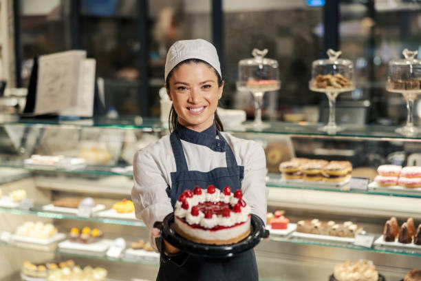 istock A happy bakery department worker offering cheese cake to a customer while standing at the supermarket. 1461539680