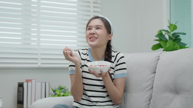 healthy food. Beautiful female girl enjoy eat yogurt, granola, fresh fruits on breakfast health in house. Happy young woman smile on morning good emotion. dieting, detox, diet, clean eat, vegetarian