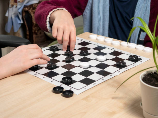istock The process of playing the board game of checkers. 1461542239