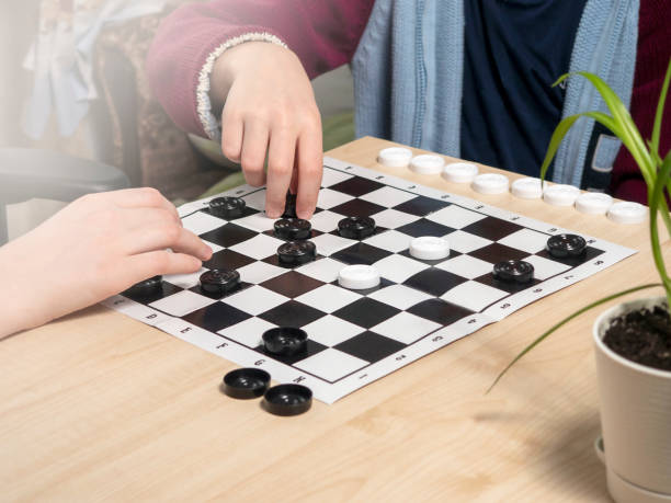 istock The process of playing the board game of checkers. 1461542240