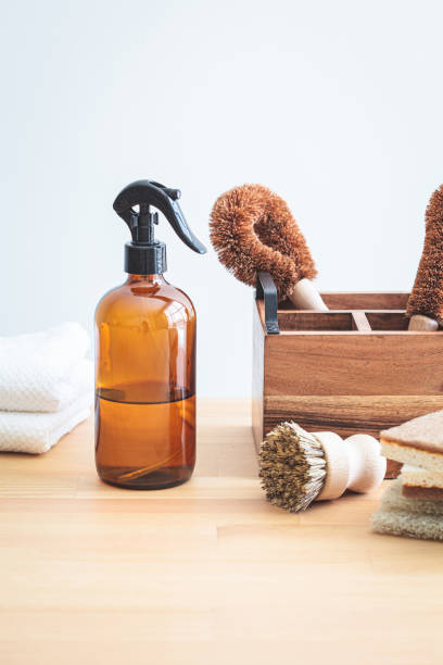 istock Zero waste eco products and tools for kitchen cleaning. Wooden brushes, coconut sponges, spray vinegar, lemon and organic soap, gray background. 1461546014