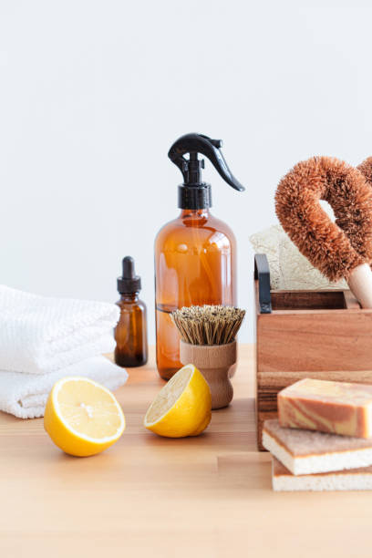 istock Zero waste eco products and tools for kitchen cleaning. Wooden brushes, coconut sponges, spray vinegar, lemon and organic soap, gray background. 1461546035