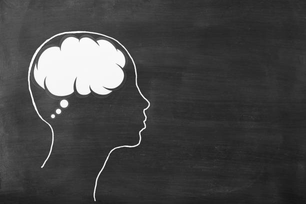 istock Chalk drawn human head shape with blank thought bubble on blackboard 1461546756