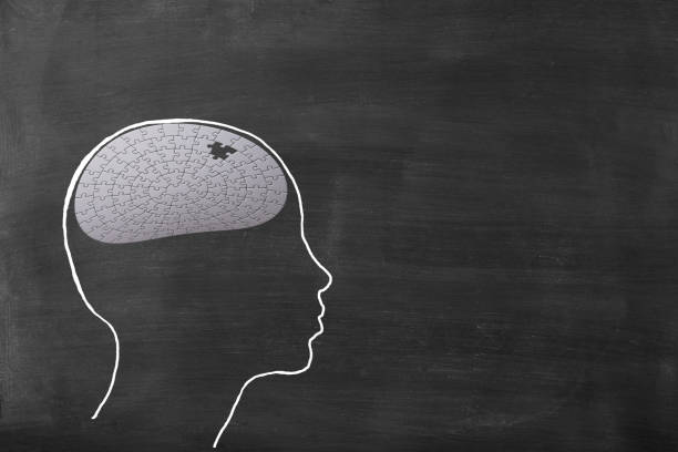 istock Chalk drawn human head shape with  jigsaw puzzle on blackboard 1461546761