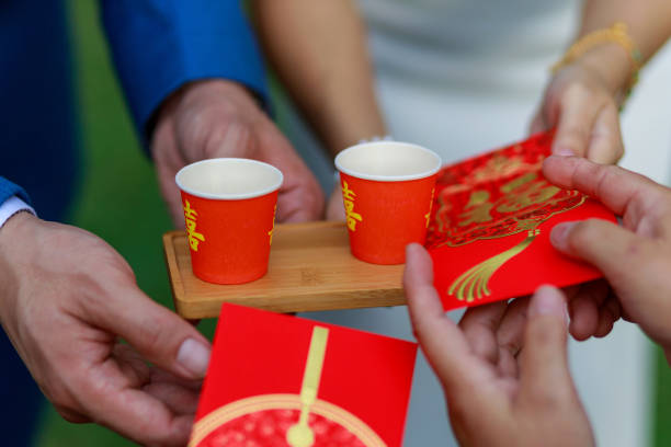 Elders giving red packet to newlywed couple during Chinese wedding tea ceremony