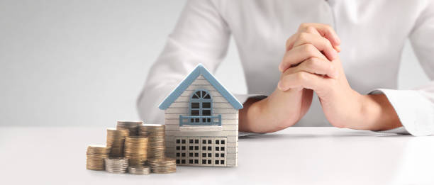 istock House Residential Structure in hand ,model house and coin 1461549312
