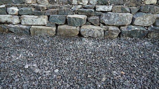Grey and black crushed stone for construction. Concrete cobble stone