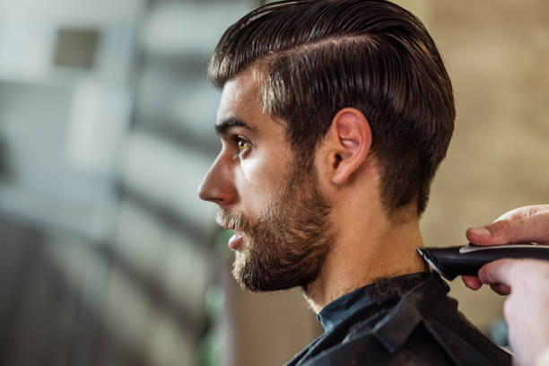 istock Young man having a haircut at barber shop. 1461552771